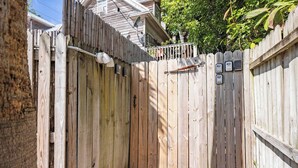 Une clôture en bois avec un portail, une antenne parabolique et une petite boîte aux lettres.