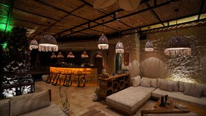 A cozy bar area with a stone counter and multiple hanging lights. - Alacati Aura Plus (Cesme)