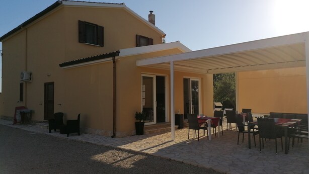 Una casa a due piani con un patio.