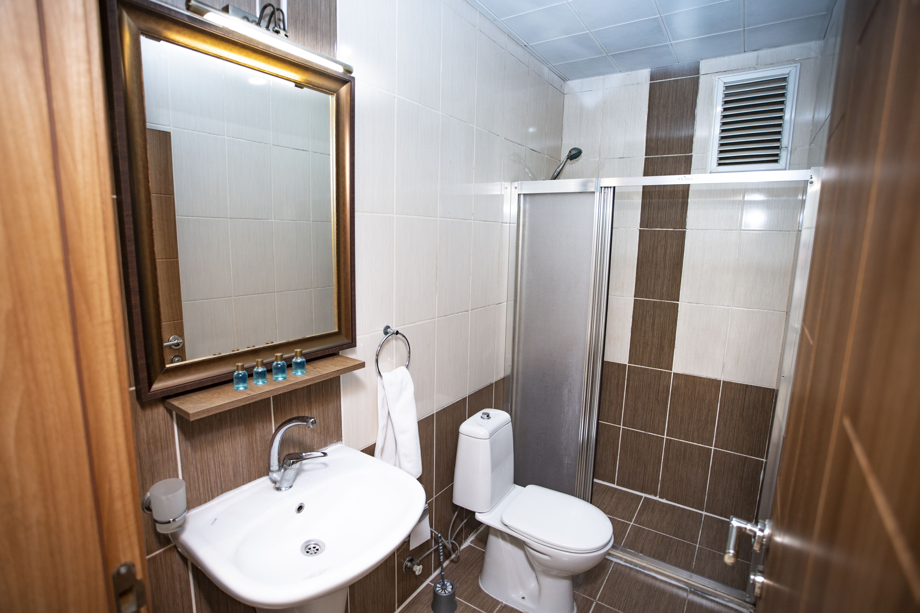 shower, hair dryer, slippers, towels