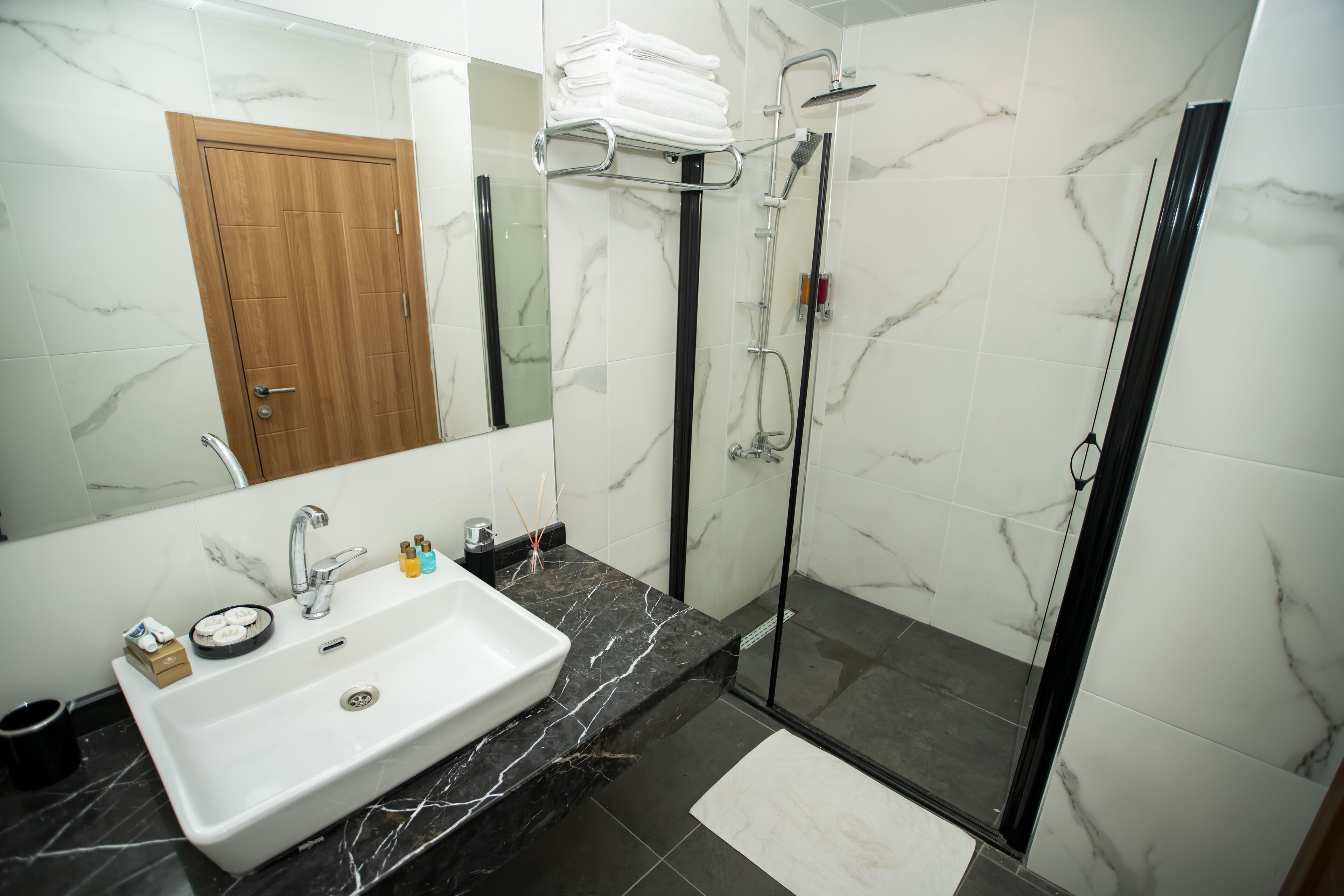 shower, hair dryer, slippers, towels