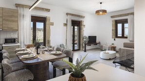 Un soggiorno moderno con angolo ristoro, cucina e salotto.