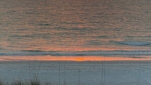 A sunset over a calm sea with a clear horizon.