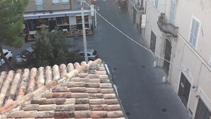 A narrow street with buildings on either side, featuring balconies and a mix of architectural styles. - Hotel La Torretta (Foligno)