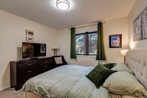 A bedroom with a bed, dresser, television, and artwork on the walls. - Hike, bike or explore Breckenridge just minutes from your doorstep (Breckenridge)