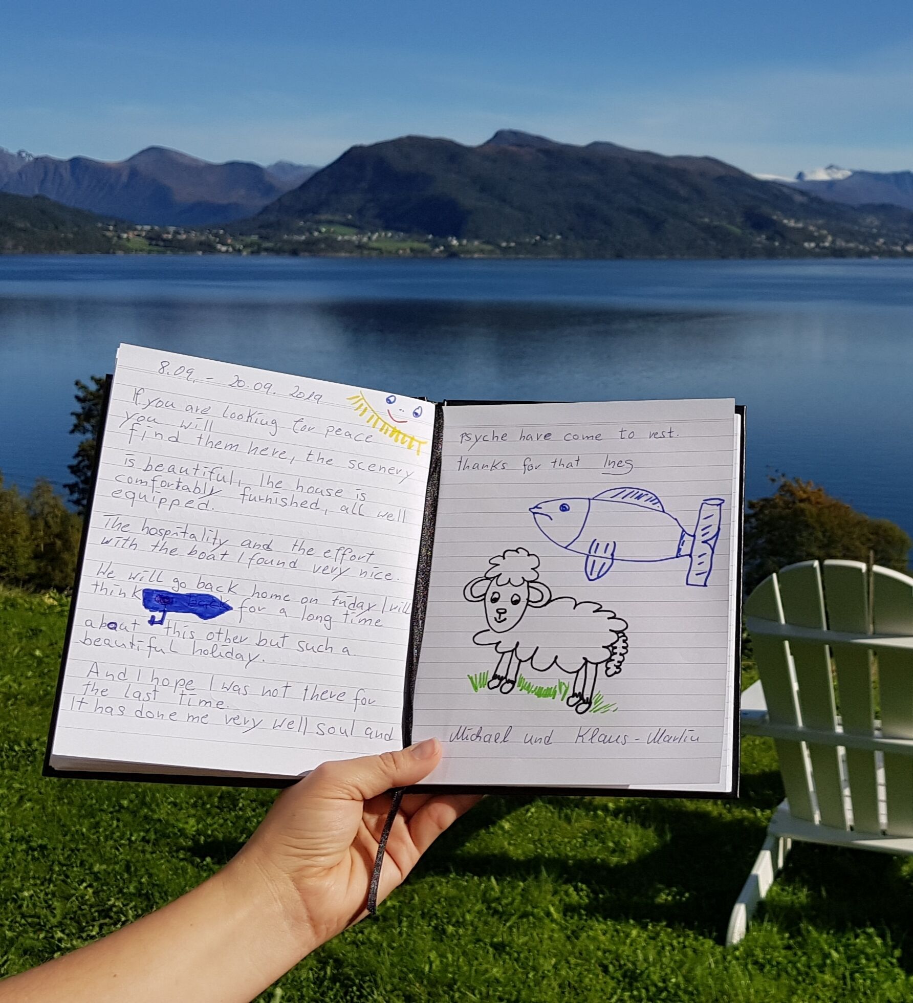 A notebook with handwritten notes and drawings, held by a hand.