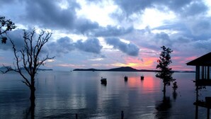 A calm lake at sunset with boats and a dock. - Cozy Winter Getaway (Pocono Pines)