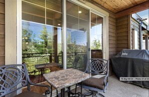 Enjoy al fresco dining on the covered deck, complete with a barbecue grill and comfortable seating for two.