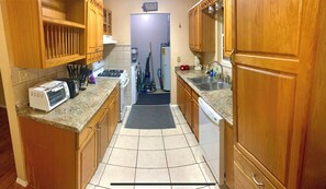 Kitchen features a stove, toaster, and ample countertop space.
