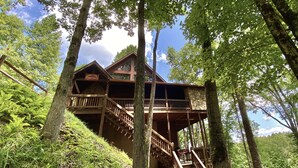 A wooden cabin with multiple levels, surrounded by trees and a clear sky. - Riverfront Cabin w/ Private Dock, Putting Green, Game Room!  3.5mi 2 Blue Ridge (Blue Ridge)