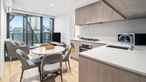 Una cocina moderna con una isla grande, electrodomésticos integrados y vistas a la ciudad.