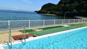 A swimming pool with a view of the sea and a hilly landscape. - Seatiger Island In Shodoshima (Shodoshima)