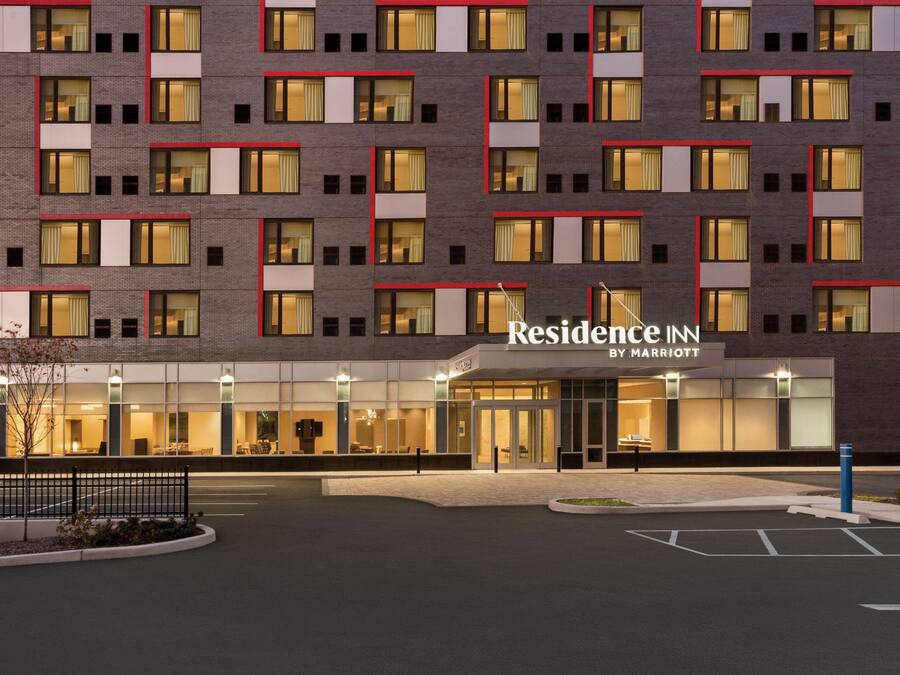 Un hotel de varios pisos con fachada moderna, amplios ventanales y señalización destacada de "Residence Inn by Marriott".