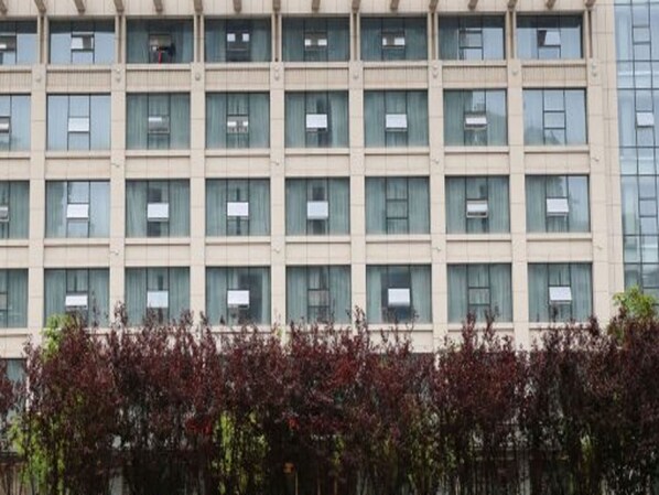 A multi-story building with a grid of windows, likely a commercial or office building. - Greentree Inn Rizhao Shanhaitian Holiday Resort Bu (Rizhao)