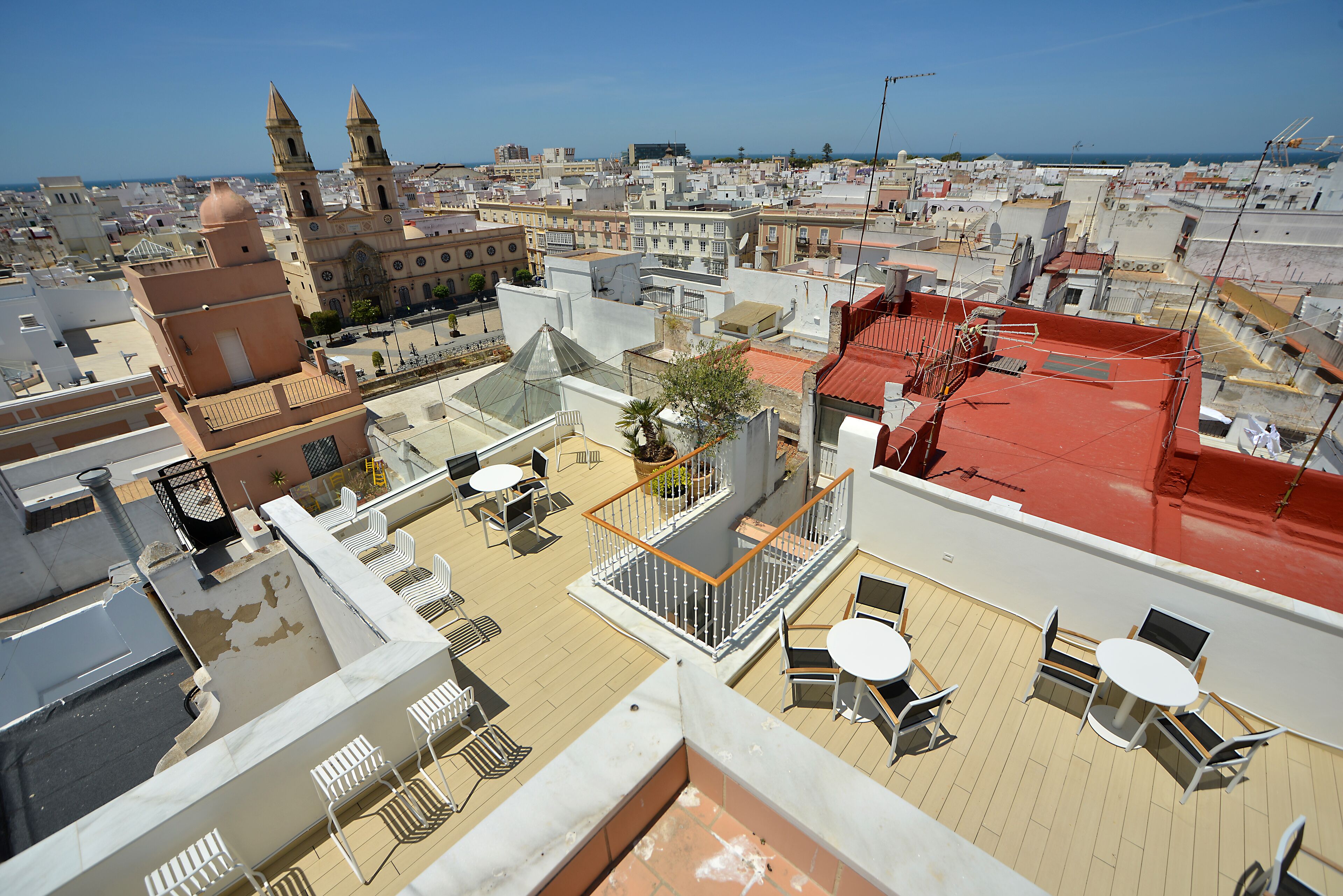 A rooftop terrace with outdoor seating and a view of the cityscape.