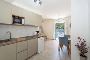 Fridge, microwave, stovetop, coffee/tea maker