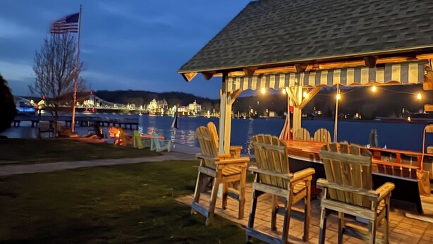 A waterfront restaurant with outdoor seating and a view of the water.