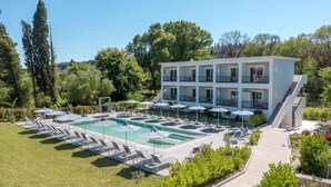A hotel with a pool area, multiple balconies, and a well-maintained garden. - La Maison Corfu - Adults Only (Corfu)
