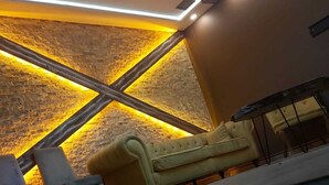 A modern lounge area with a sofa, a chair, and a small table. - Otel Bostanci (Izmit)