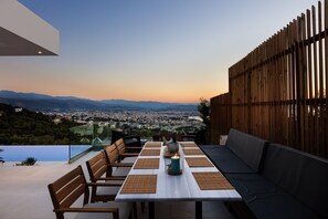 Enjoy a serene dining experience with a panoramic view of the city and distant mountains.