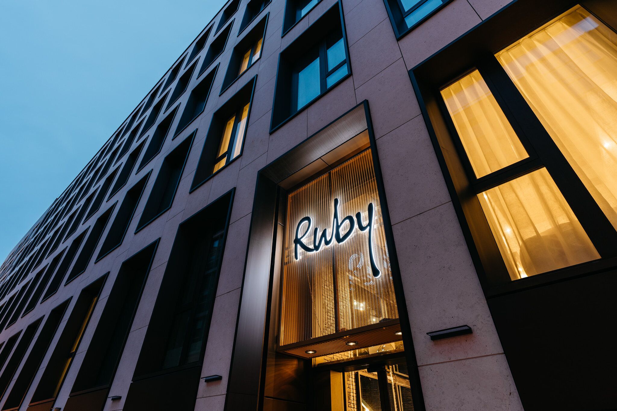 A building with a prominent 'Ruby' sign, large windows, and a modern architectural design.