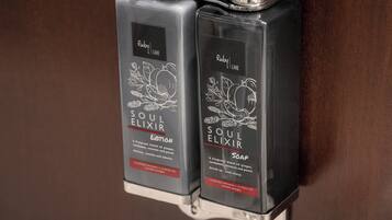 Two dispensers of Soul Elixir soap with a ginger and coconut scent.