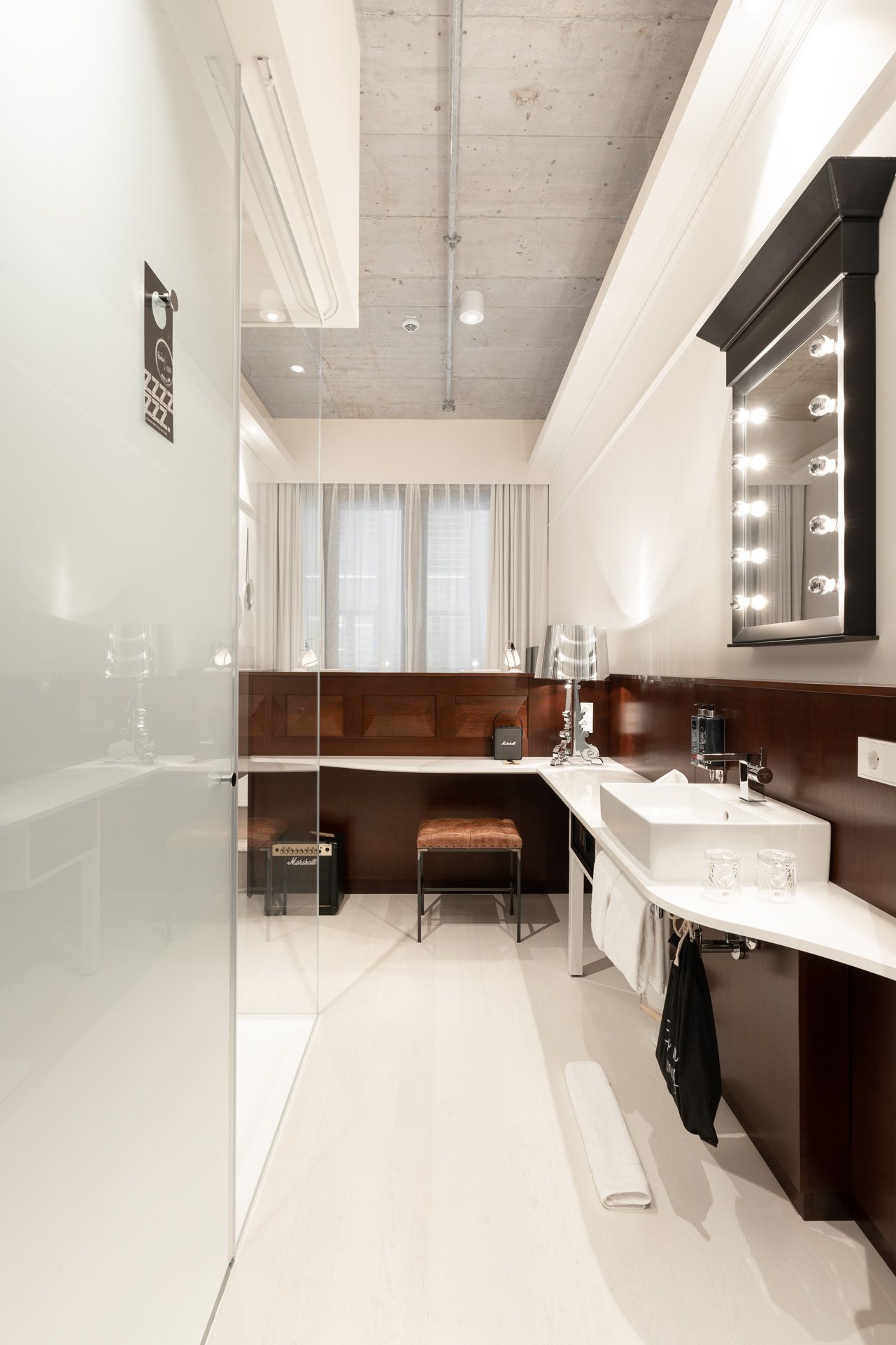 A modern bathroom with a vanity, mirror, and lighting.