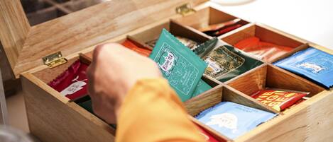 A wooden box with compartments containing various tea packets.
