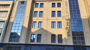 A hotel with a classic facade, multiple windows, and a prominent sign. - Baijan Hotel Baku (Baku)