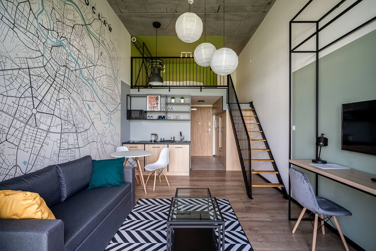 A modern living space with a sofa, coffee table, and a map on the wall.