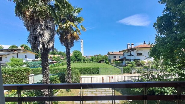 A residential area with houses, a tower, and a clear sky.