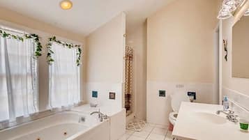 A bathroom with a bathtub, a shower, and a toilet.