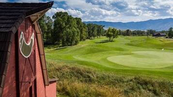 Stunning golf course views of manicured fairways and greens, set against a picturesque mountain backdrop.