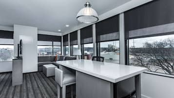 Premium bedding, desk, laptop workspace, blackout drapes