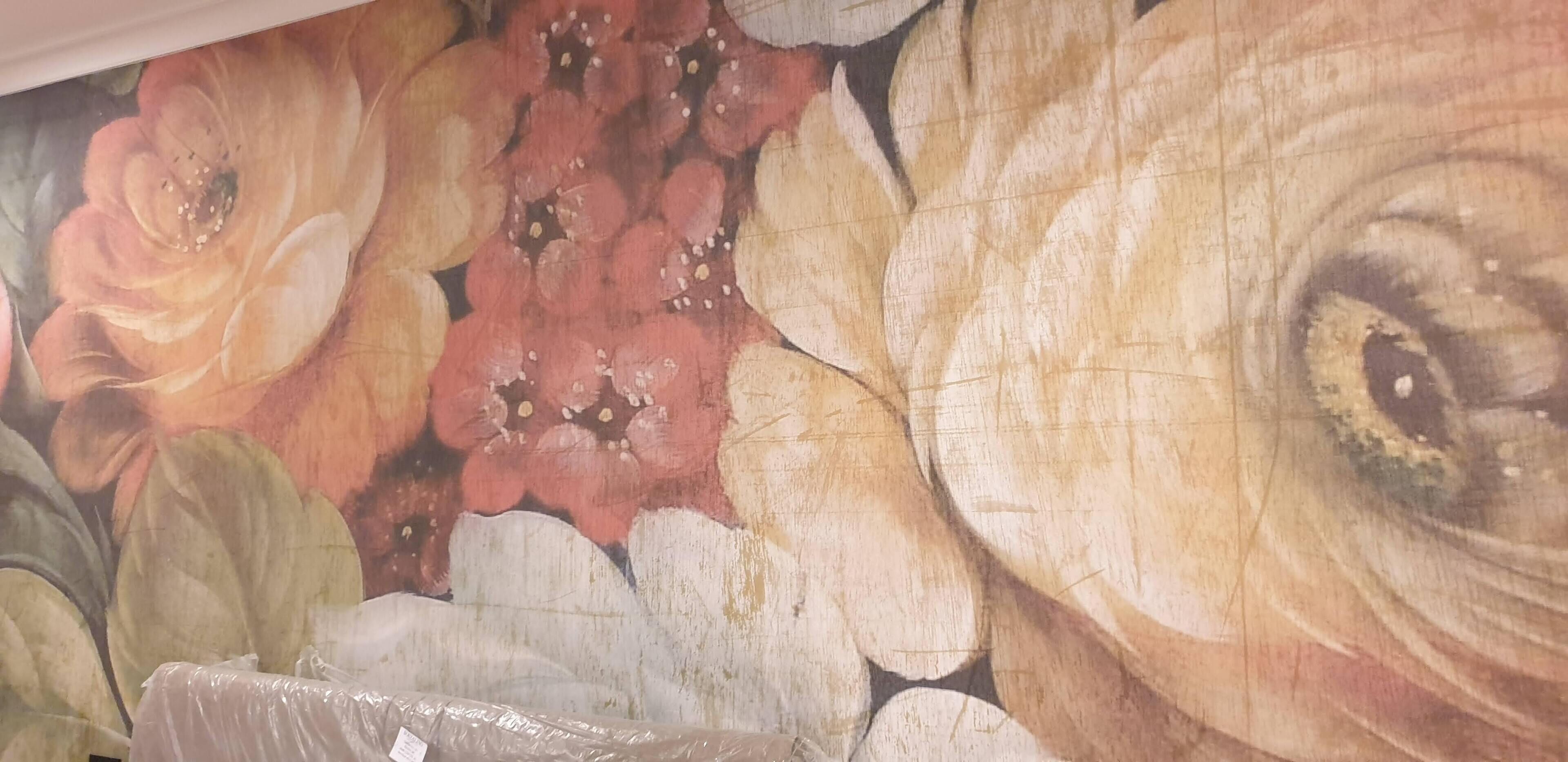 A close-up of a floral mural with large flowers and leaves.