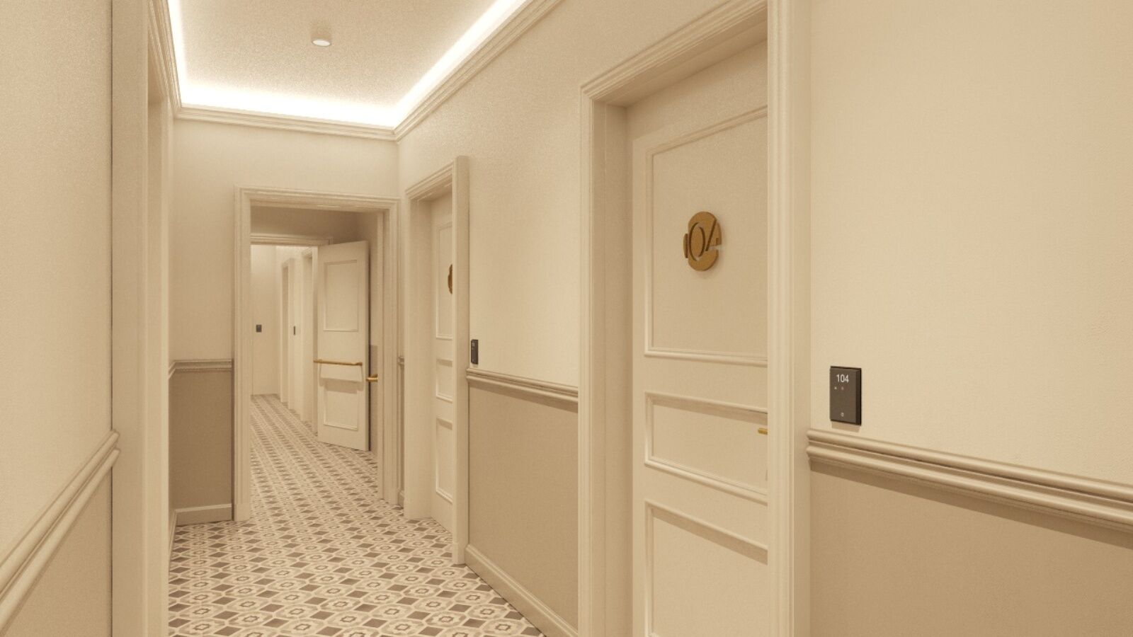 Un corridoio d'albergo con pavimento a motivi, pareti bianche e porte con numeri civici.