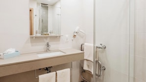 A modern bathroom with a glass shower enclosure, a sink with a mirror, and a towel rack. - Gasthof-Metzgerei-Pension Schierlitz (Rimbach)