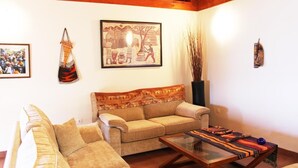 A living room with a sofa, a coffee table, and a painting on the wall. - The best views of the island of Tenerife (Juan Fernández)