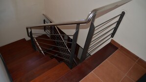 A wooden staircase with metal handrails and a tiled floor. - The best views of the island of Tenerife (Juan Fernández)