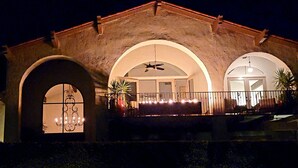 A building with arched windows and a balcony with lights.