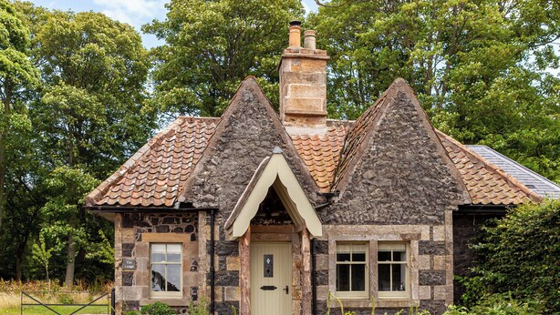 A stone cottage with a tiled roof, a chimney, and a small porch. - The Lodge @ East Neuk Orchards (Pittenweem, near Anstruther)