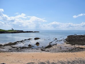 A coastal landscape with a lighthouse, rocky shoreline, and calm sea. - The Lodge @ East Neuk Orchards (Pittenweem, near Anstruther)