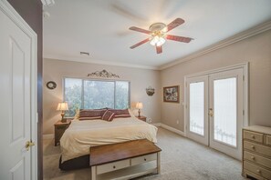 A bedroom with a bed, bedside tables, a ceiling fan, and a window with blinds. - Classy Guest Suite in Gorgeous Lake Community (Gilbert)