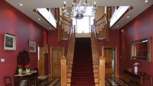 A grand staircase with a red carpet, wooden railings, and a chandelier. - Large Luxury House in Excellent Location. Ideal for families  (Killarney)