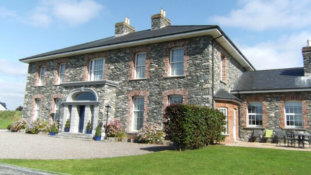 A large stone building with multiple windows and a central entrance. - Large Luxury House in Excellent Location. Ideal for families  (Killarney)