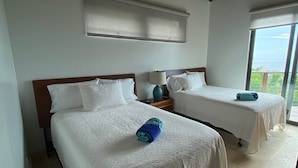 A hotel room with two beds, a ceiling fan, a large window, and a view of the outdoors. - Eureka Villa! Stunning Views in Paradise! 3BR, 3.5BA (Rendezvous Bay)