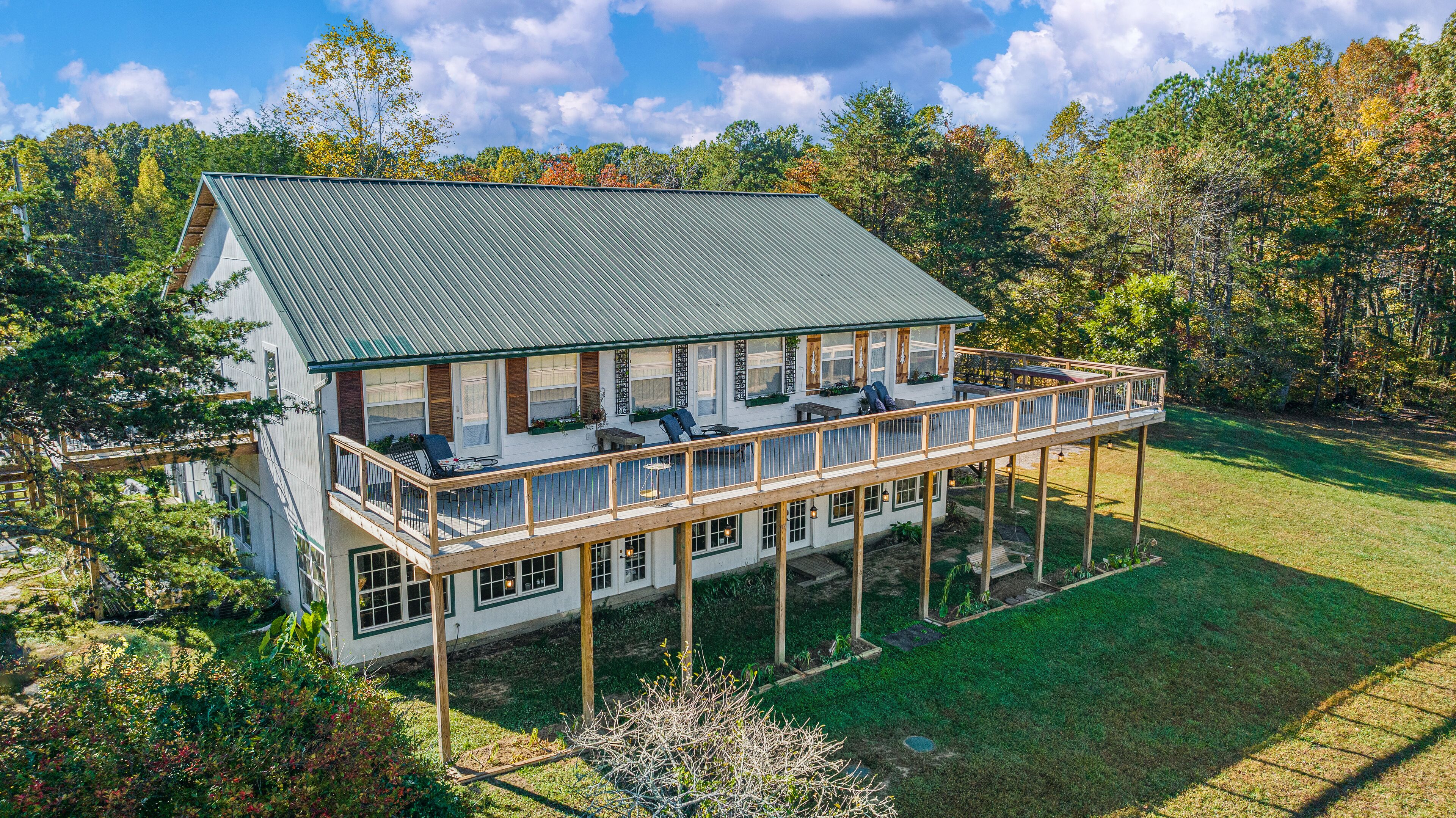 A two-story house with a balcony and a deck.