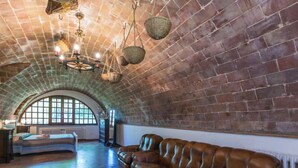 A spacious loft with a high arched ceiling, exposed brick walls, and a leather sofa. - Poggio al Colle by Interhome (Montaione)