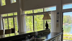A kitchen with a granite countertop, stainless steel sink, and white cabinetry. - Nero's Point Lake Martin  Home
Pet friendly, Great for Football Weekends (Eclectic)