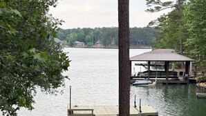 A lakeside view with a dock, a covered pavilion, and two Adirondack chairs. - Nero's Point Lake Martin  Home
Pet friendly, Great for Football Weekends (Eclectic)
